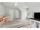 Bright living room with neutral tones, comfortable seating, and natural light from large windows at 2713 Misty Rock Cv, Dacula, GA 30019