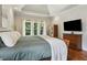 Bright main bedroom featuring trey ceiling, natural light, and traditional furnishings at 2713 Misty Rock Cv, Dacula, GA 30019