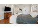 Main bedroom with hardwood floors, flat screen TV and access to ensuite bathroom at 2713 Misty Rock Cv, Dacula, GA 30019