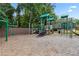 Community playground with slides, swings, climbing structures, and a wood chip ground cover at 2713 Misty Rock Cv, Dacula, GA 30019