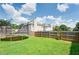 A spacious back yard with well-maintained grass and a wooden privacy fence at 1574 Leonard St, Hampton, GA 30228