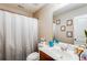 Bathroom featuring a single sink vanity, toilet, and shower with curtain at 1574 Leonard St, Hampton, GA 30228