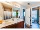 Elegant bathroom with double vanity, large mirror, and ample lighting, adjacent to a separate water closet at 1574 Leonard St, Hampton, GA 30228