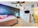 Bedroom with chalkboard wall, dresser with television, and a vanity table at 1574 Leonard St, Hampton, GA 30228