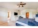 Bright bedroom featuring a ceiling fan, office area, and ensuite bathroom, providing a comfortable and functional space at 1574 Leonard St, Hampton, GA 30228