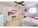 Cozy bedroom featuring carpet flooring, ceiling fan, and comfortable bed with pink accents at 1574 Leonard St, Hampton, GA 30228