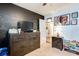 Bedroom showcases a chalkboard wall, complementing the dark wood dresser, and art-adorned walls at 1574 Leonard St, Hampton, GA 30228