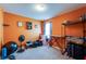An orange bedroom featuring carpeted floors and ample space for storage at 1574 Leonard St, Hampton, GA 30228