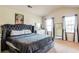 Cozy bedroom with plush carpeting, large windows, and vaulted ceilings, perfect for relaxation at 1574 Leonard St, Hampton, GA 30228