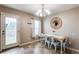 An eat-in dining area with modern decor, access to the backyard, and lots of natural light at 1574 Leonard St, Hampton, GA 30228