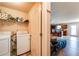 Bright laundry room with modern appliances, open shelving, and easy access to the kitchen, all designed for convenience at 1574 Leonard St, Hampton, GA 30228