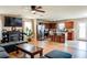 An open-concept living room with hardwood floors, a fireplace and access to the kitchen at 1574 Leonard St, Hampton, GA 30228