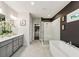 Beautiful bathroom featuring a double sink vanity, standalone tub, and glass enclosed shower at 1821 Huntington Hills Nw Ln, Atlanta, GA 30309