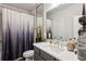Bathroom with large mirror, single sink vanity, and shower with gray gradient shower curtain at 1821 Huntington Hills Nw Ln, Atlanta, GA 30309