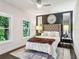 Bedroom with neutral tones, two windows for natural light, and a decorative ceiling fan at 1821 Huntington Hills Nw Ln, Atlanta, GA 30309