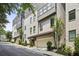 Modern townhome exterior with painted brick, attached garages, and manicured landscaping at 1821 Huntington Hills Nw Ln, Atlanta, GA 30309