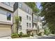 Exterior view of a new townhome featuring a two-car garage and manicured landscaping at 1821 Huntington Hills Nw Ln, Atlanta, GA 30309