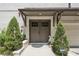 Charming double front doors flanked by lush greenery and a decorative statue at 1821 Huntington Hills Nw Ln, Atlanta, GA 30309