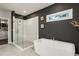 Modern main bathroom features a soaking tub, separate shower, and neutral gray tile at 1821 Huntington Hills Nw Ln, Atlanta, GA 30309