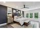 Stylish main bedroom features dark accent wall, a ceiling fan, and multiple windows at 1821 Huntington Hills Nw Ln, Atlanta, GA 30309