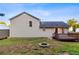 Back exterior featuring a two-story house with a wooden deck, fire pit, and a storage shed, perfect for outdoor gatherings at 421 River Trace Dr, Villa Rica, GA 30180