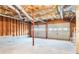Spacious unfinished basement with exposed ceiling, concrete floors, and two garage doors, ready for customization at 421 River Trace Dr, Villa Rica, GA 30180