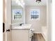Updated bathroom features a modern vanity with granite countertop and wood-look flooring, complemented by natural light at 421 River Trace Dr, Villa Rica, GA 30180