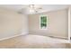 Bright bedroom with a ceiling fan and a window providing ample natural light, creating a cozy atmosphere at 421 River Trace Dr, Villa Rica, GA 30180