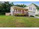 This well-maintained home features a front porch, two-car garage, green lawn, and privacy fencing in a residential area at 421 River Trace Dr, Villa Rica, GA 30180