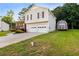 This charming home features a front porch, two-car garage, landscaped yard, and an outbuilding for extra storage at 421 River Trace Dr, Villa Rica, GA 30180