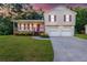 Charming two-story home with vinyl siding, a front porch, attached two-car garage, and a well-manicured front lawn at 421 River Trace Dr, Villa Rica, GA 30180