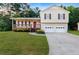 Charming two-story home with vinyl siding, a front porch, attached two-car garage, and a well-manicured front lawn at 421 River Trace Dr, Villa Rica, GA 30180