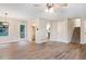 Spacious living room boasts hardwood floors, a modern ceiling fan, and stairs to upper floor at 421 River Trace Dr, Villa Rica, GA 30180