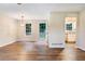 Spacious living room features hardwood floors, neutral walls, large windows, and backyard access at 421 River Trace Dr, Villa Rica, GA 30180