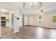 Spacious living room with hardwood floors, modern ceiling fan, plenty of windows, and open access to the kitchen at 421 River Trace Dr, Villa Rica, GA 30180