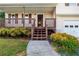 Inviting front porch features wood railings, steps, and landscaping, leading to the home's entrance at 421 River Trace Dr, Villa Rica, GA 30180
