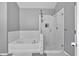 Updated bathroom including a glass enclosed shower and tiled tub surround at 4349 Kousa Rd # 4, Austell, GA 30106