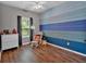 Charming bedroom featuring a ceiling fan, hardwood floors, and painted accent wall at 4349 Kousa Rd # 4, Austell, GA 30106