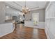 Open dining area with hardwood floors, stylish lighting, and seamless flow to living area at 4349 Kousa Rd # 4, Austell, GA 30106