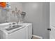 Clean laundry room showcasing a washer, dryer, and storage shelves for convenience at 4349 Kousa Rd # 4, Austell, GA 30106
