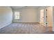 Neutral bedroom with a window, door and access to a bathroom at 443 Lothbury Ave, Locust Grove, GA 30248