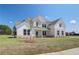 Inviting two-story home with brick and siding, complemented by blue shutters and a well-manicured lawn at 443 Lothbury Ave, Locust Grove, GA 30248