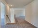 Carpeted upstairs hallway with stairs on the left and rooms leading off to the right at 443 Lothbury Ave, Locust Grove, GA 30248