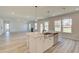Bright kitchen with a stainless steel sink, quartz countertops, and hardwood floors, with lots of natural light at 443 Lothbury Ave, Locust Grove, GA 30248