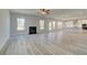 Open-concept living room with light wood flooring and a fireplace at 443 Lothbury Ave, Locust Grove, GA 30248
