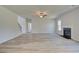 Cozy living room with a fireplace and modern hardwood floors at 443 Lothbury Ave, Locust Grove, GA 30248
