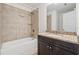 Well-lit bathroom featuring a shower-tub combo, granite countertop, and dark cabinets at 6761 Cedar Glen Rd, Peachtree Corners, GA 30360