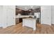 Modern kitchen with dark cabinets, stainless appliances, and island with granite countertops at 6761 Cedar Glen Rd, Peachtree Corners, GA 30360