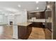 Modern kitchen boasts dark cabinets, granite countertops, and a stainless steel refrigerator at 6761 Cedar Glen Rd, Peachtree Corners, GA 30360