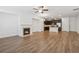Spacious living area with a fireplace, hardwood flooring, and adjacent kitchen at 6761 Cedar Glen Rd, Peachtree Corners, GA 30360